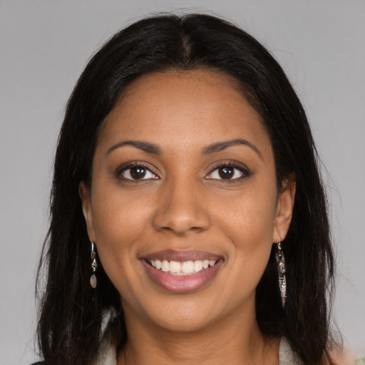 Joyful black young-adult female with medium  brown hair and brown eyes