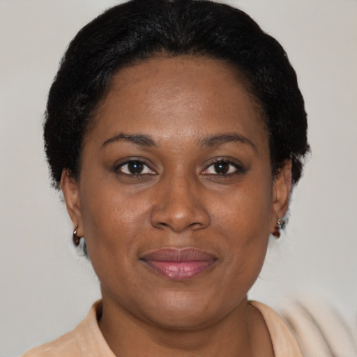 Joyful latino adult female with short  brown hair and brown eyes