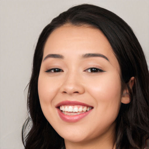 Joyful white young-adult female with long  black hair and brown eyes