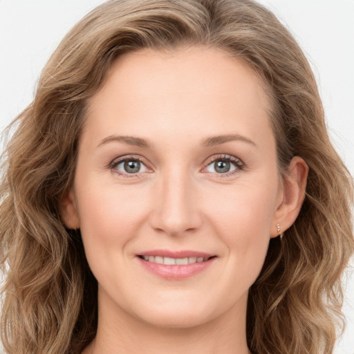 Joyful white young-adult female with long  brown hair and green eyes