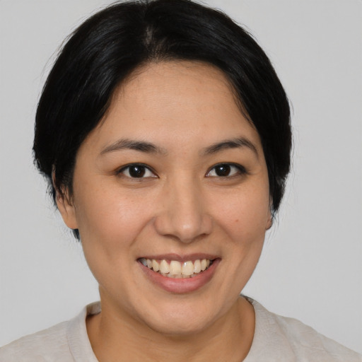 Joyful asian young-adult female with medium  black hair and brown eyes