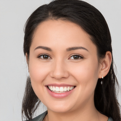 Joyful white young-adult female with long  brown hair and brown eyes