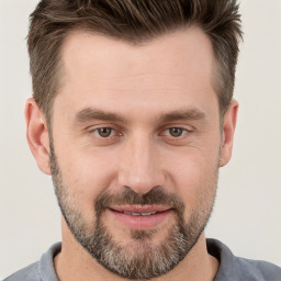 Joyful white adult male with short  brown hair and brown eyes