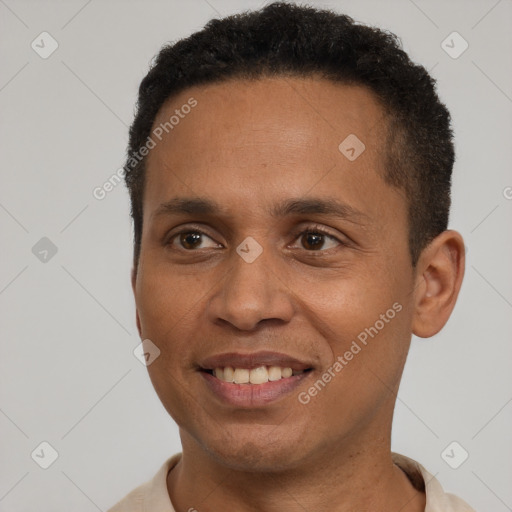 Joyful latino young-adult male with short  brown hair and brown eyes