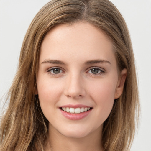 Joyful white young-adult female with long  brown hair and green eyes