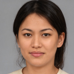 Joyful latino young-adult female with medium  brown hair and brown eyes