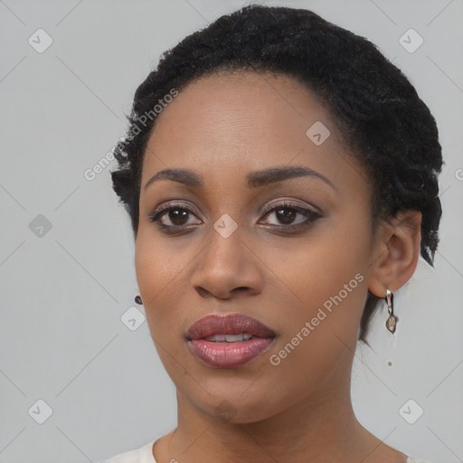 Joyful black young-adult female with short  black hair and brown eyes