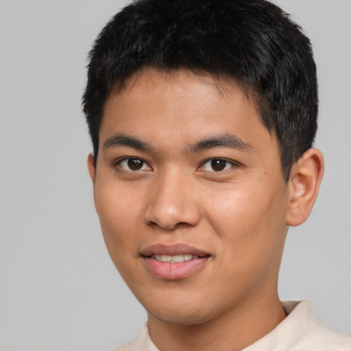 Joyful asian young-adult male with short  black hair and brown eyes