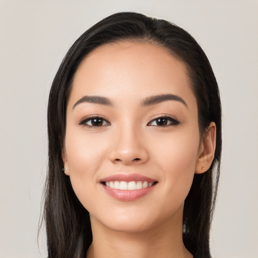 Joyful white young-adult female with long  black hair and brown eyes