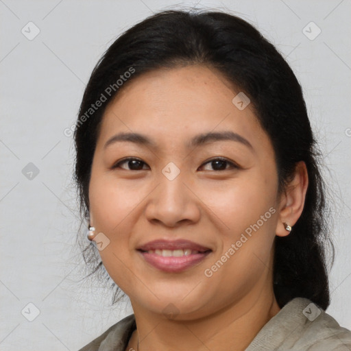 Joyful latino adult female with medium  brown hair and brown eyes