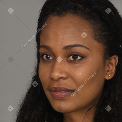 Joyful black young-adult female with long  black hair and brown eyes