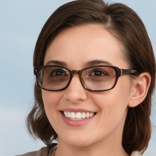 Joyful white young-adult female with medium  brown hair and blue eyes