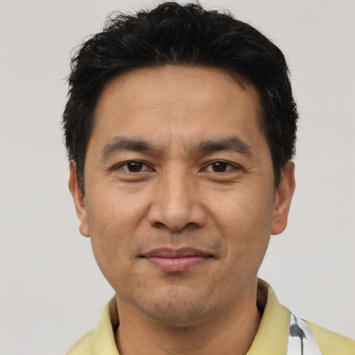 Joyful asian adult male with short  black hair and brown eyes