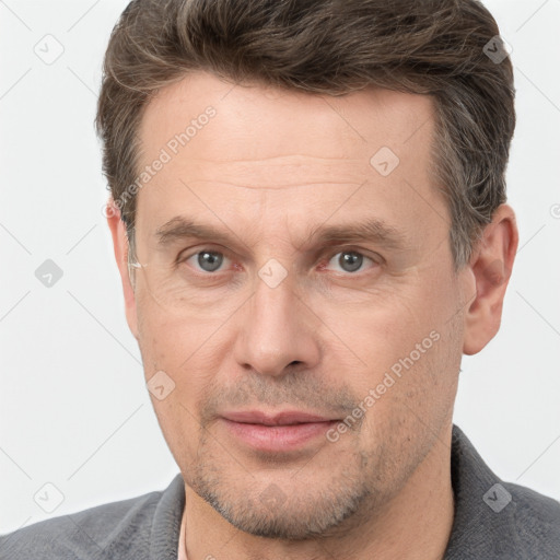 Joyful white adult male with short  brown hair and grey eyes