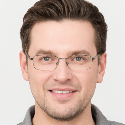 Joyful white adult male with short  brown hair and grey eyes