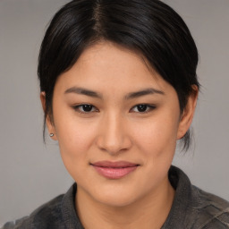 Joyful asian young-adult female with medium  brown hair and brown eyes