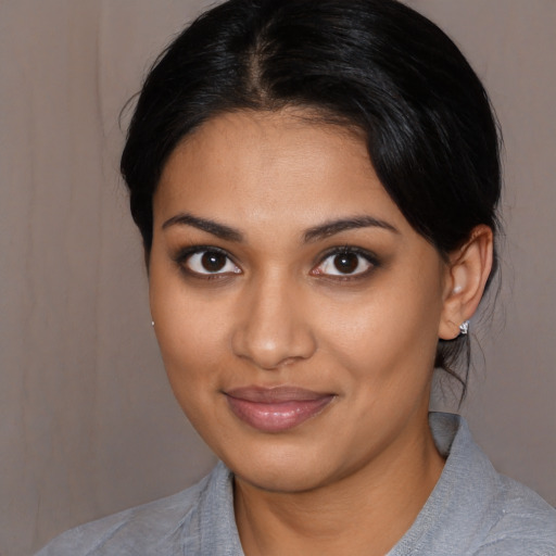 Joyful latino young-adult female with medium  black hair and brown eyes