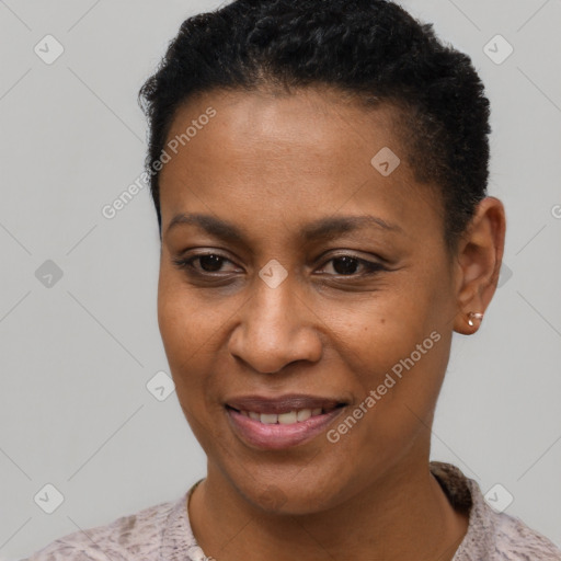 Joyful black young-adult female with short  black hair and brown eyes