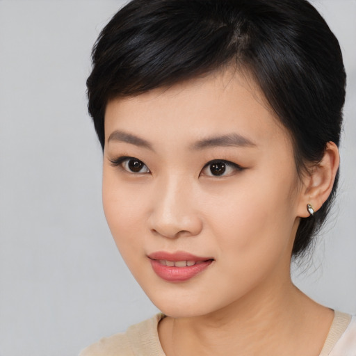 Joyful asian young-adult female with medium  black hair and brown eyes