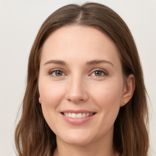 Joyful white young-adult female with long  brown hair and grey eyes