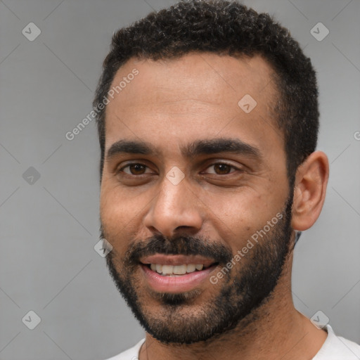 Joyful black young-adult male with short  black hair and brown eyes