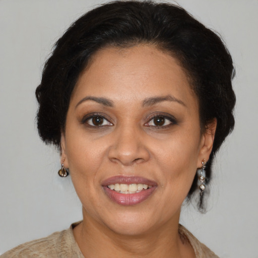 Joyful latino adult female with medium  brown hair and brown eyes