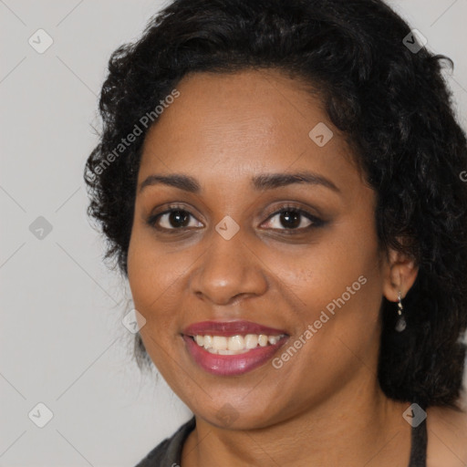 Joyful black young-adult female with long  black hair and brown eyes