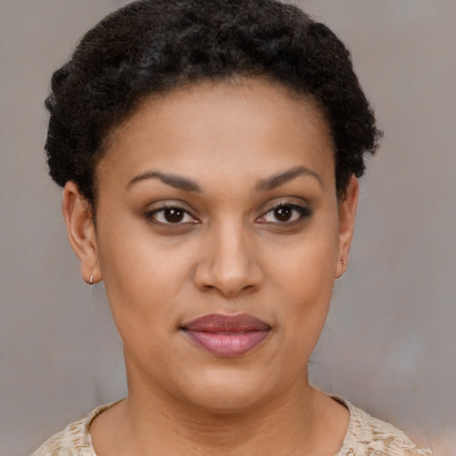 Joyful black young-adult female with short  brown hair and brown eyes