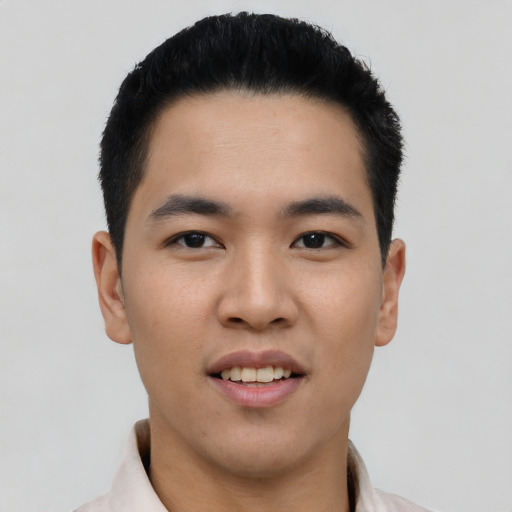 Joyful asian young-adult male with short  black hair and brown eyes