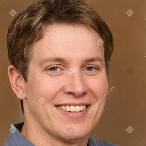 Joyful white adult male with short  brown hair and grey eyes