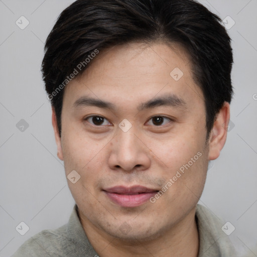 Joyful asian young-adult male with short  brown hair and brown eyes