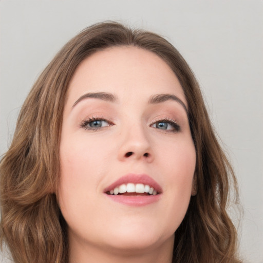 Joyful white young-adult female with long  brown hair and green eyes