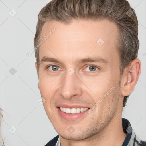 Joyful white adult male with short  brown hair and brown eyes