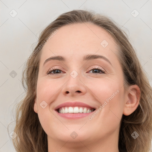 Joyful white young-adult female with medium  brown hair and blue eyes