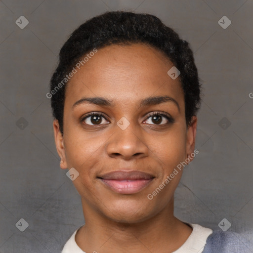 Joyful black young-adult female with short  black hair and brown eyes