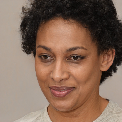Joyful black adult female with short  brown hair and brown eyes