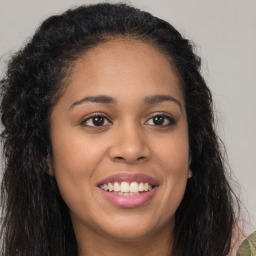 Joyful latino young-adult female with long  brown hair and brown eyes