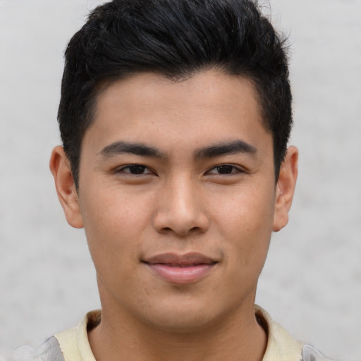 Joyful asian young-adult male with short  brown hair and brown eyes