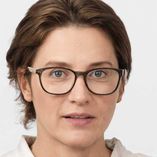 Joyful white adult female with medium  brown hair and grey eyes