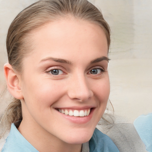 Joyful white young-adult female with medium  brown hair and blue eyes