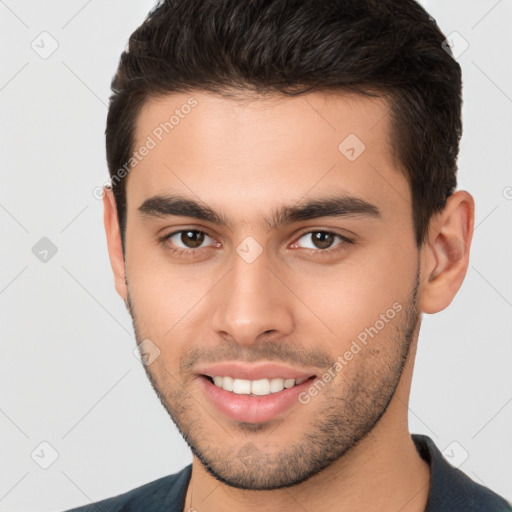 Joyful white young-adult male with short  brown hair and brown eyes