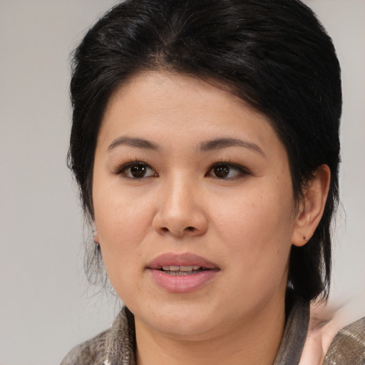 Joyful asian young-adult female with medium  brown hair and brown eyes