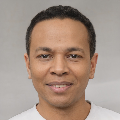 Joyful latino adult male with short  black hair and brown eyes
