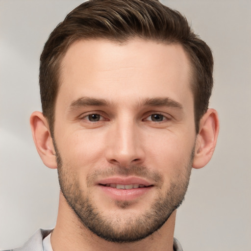 Joyful white young-adult male with short  brown hair and brown eyes