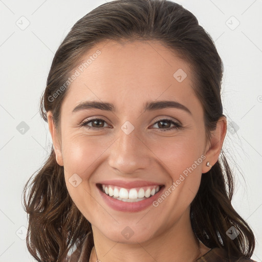 Joyful white young-adult female with long  brown hair and brown eyes