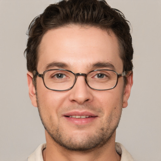 Joyful white young-adult male with short  brown hair and grey eyes