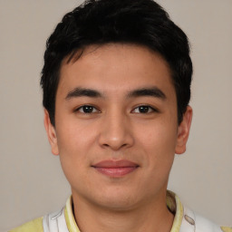 Joyful asian young-adult male with short  black hair and brown eyes