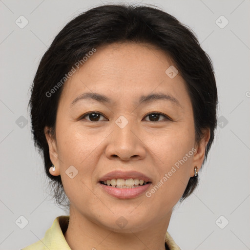 Joyful asian adult female with medium  brown hair and brown eyes