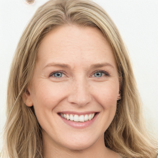 Joyful white young-adult female with long  brown hair and blue eyes