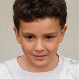 Joyful white child male with short  brown hair and brown eyes